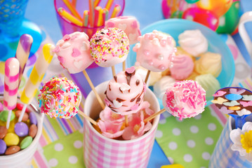 birthday party table with marshmallow pops and other sweets for