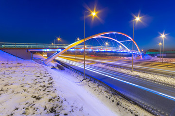 Foothpath bridge over bypass of Gdansk at night, Poland