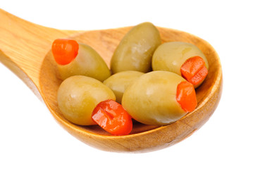 stuffed green olives and wooden spoon