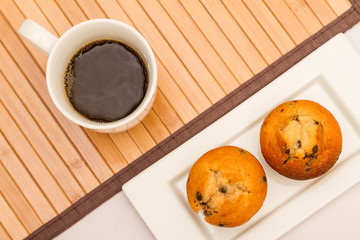 Vanilla with chocolate chips Muffins with a cup of coffee