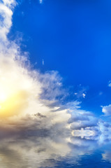 Obraz na płótnie Canvas Bright, deep blue sky and white clouds with the setting sun