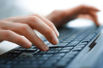 Fotobehang Close-up of typing female hands on keyboard © fotomaximum