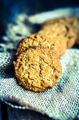 Vintage oatmeal cookies on rustic wooden background