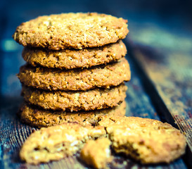 Vintage oatmeal cookies on rustic wooden background