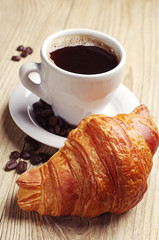 Coffee cup with a croissant