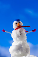 Christmas snowman with pink gloves outdoor. Winter season.