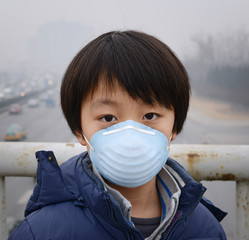 Asian boy wearing mouth mask against air pollution (Beijing)