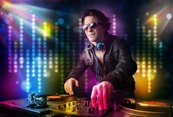 Dj playing songs in a disco with light show