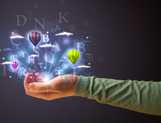 Letters and balloons in the hand of a woman