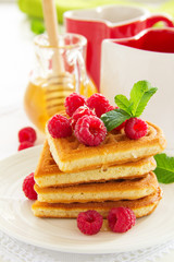 Waffles with raspberry, honey and chocolate.