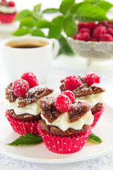 Chocolate muffins with raspberries and cream.