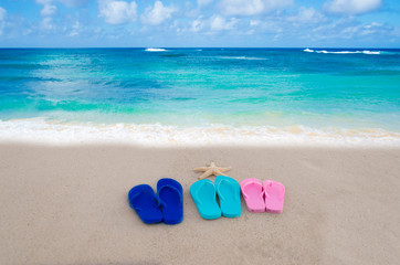 Fototapeta na wymiar Flip flops on the beach