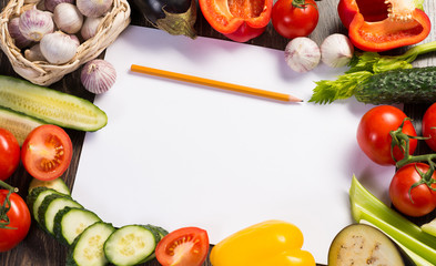 Vegetables tiled around a sheet of paper