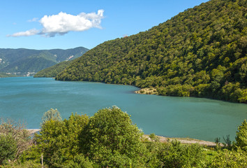 Fototapeta na wymiar view of the blue lake and green hills on the background of blue