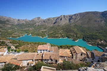 Fototapeta na wymiar Guadalest lake and village. Reservoir and tiled roofs.