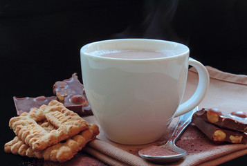 Cup of hot cocoa with tasty biscuit