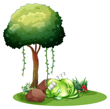 A fat green monster sleeping under the tree