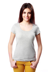 Fototapeta premium Young happy woman standing on white background