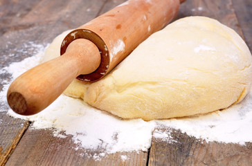 rolling pin and dough on a wooden table