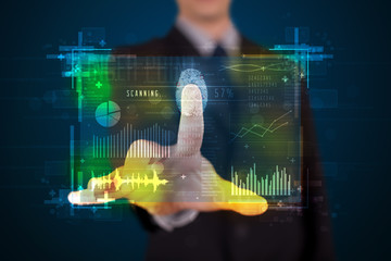 Young businessman pressing modern technology panel with finger p