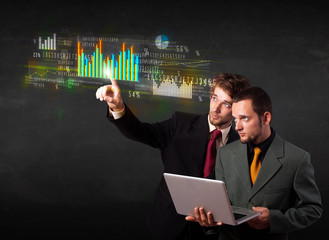 Young business people touching colorful charts and diagrams