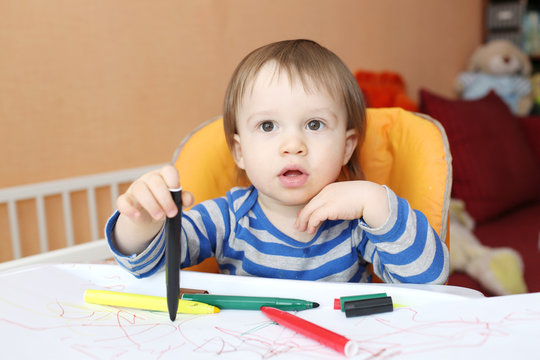 baby boy with pens at home