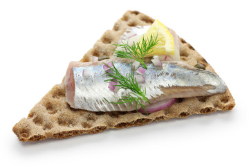 pickled herring on crisp bread, cold appetizer