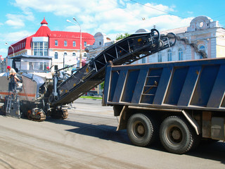 Cold planer machine loading milled asphalt into truck - obrazy, fototapety, plakaty