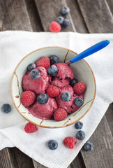 Berry ice cream decorated with fresh blueberries and raspberries