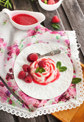 Delicious dessert with raspberry sauce and fresh berries