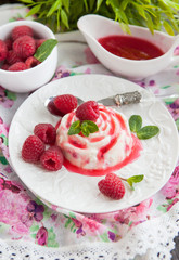 Delicious dessert with raspberry sauce and fresh berries