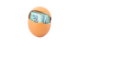 Concept image of Malaysia currency inside chicken egg over white
