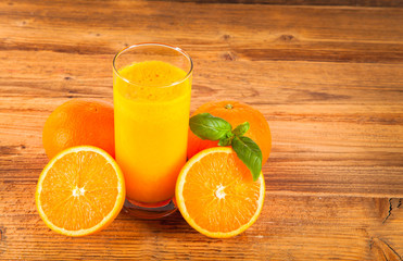 Fresh orange juice and fruits on wood plant