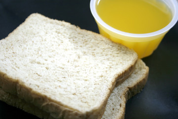 bread and orange juice on dish