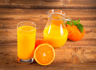 Fresh orange and carrot juice on wood 