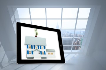 Composite image of house with price tag on tablet screen