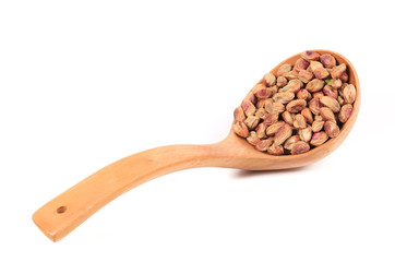 Wooden spoon with pistachios.