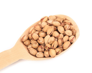 Wooden spoon with pistachios.