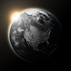 Obraz na płótnie Canvas Sun over North America on dark planet Earth