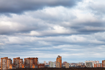 Fototapeta na wymiar sky with blue clouds over urban houses