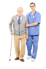 Young doctor helping an elderly gentleman with crutch