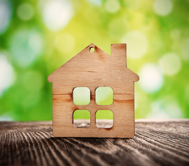 wooden house symbol on nature background