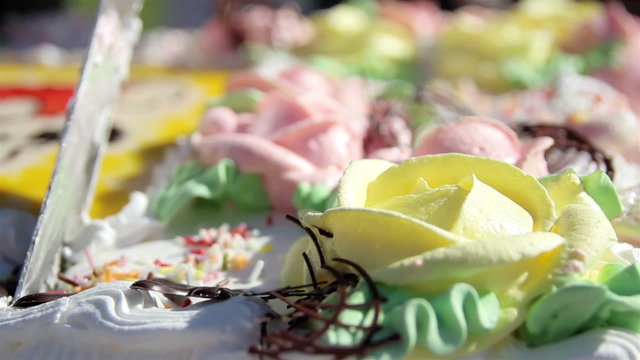 Slicing a cake with flower designs