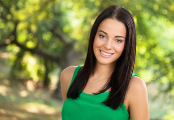 Young woman with toothy smile outdoors portrait