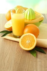Obraz na płótnie Canvas Citrus press and oranges on table on blue background