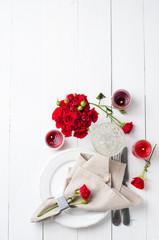 Festive table setting with red roses