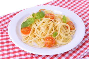 Delicious spaghetti with tomatoes on plate on table close-up