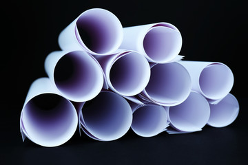 White paper rolls on black background close-up