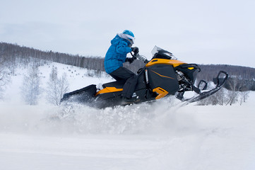 Man on snowmobile in winter mountain - 61865546
