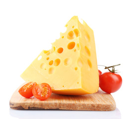 Piece of cheese and tomatoes, on wooden board, isolated on